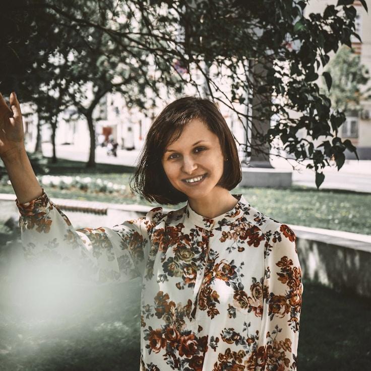 Kaveri Mehta, Lead Design Curator at Distributed Process Architecture, reviewing corporate floral arrangements